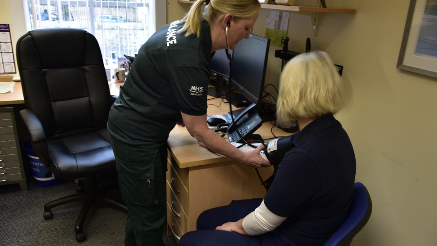 An Advanced Practitioner treats a patient in her surgery