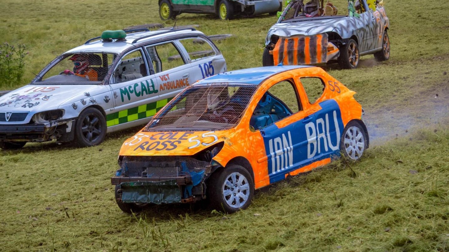 Cars covered with advertising racing each other