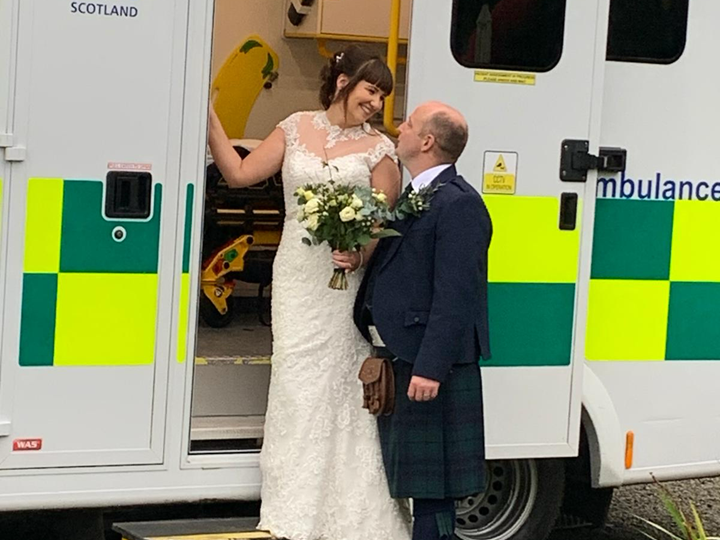 Wayne and Sarah look into each other's eyes in the bottom of an ambulance on their wedding day